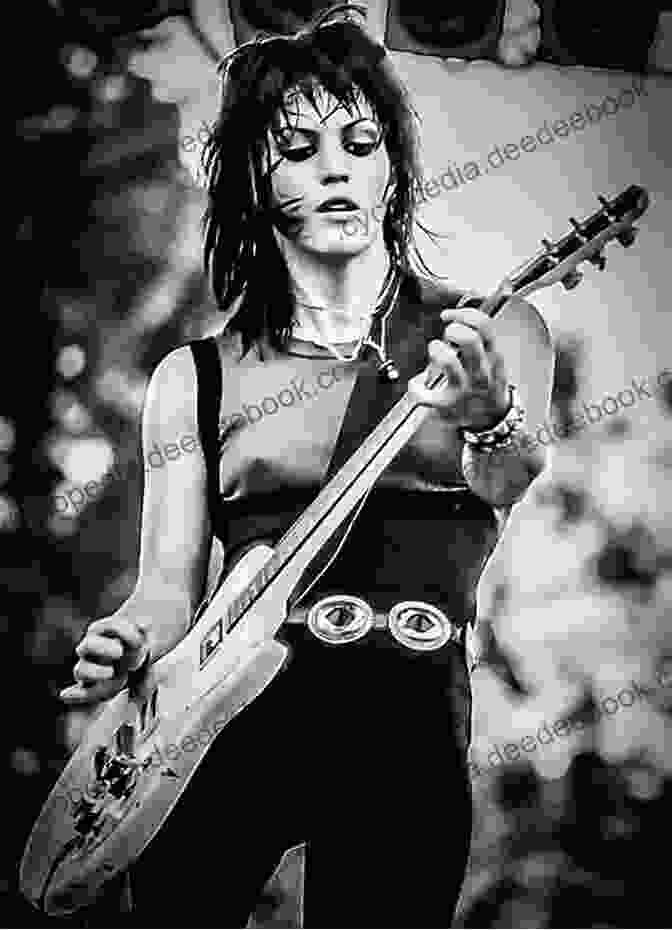 A Black And White Photo Of Joan Jett Performing On Stage, With A Guitar In Her Hand And A Determined Expression On Her Face The Fans Have Their Say #14 Joan Jett :: Punk S Not Dead