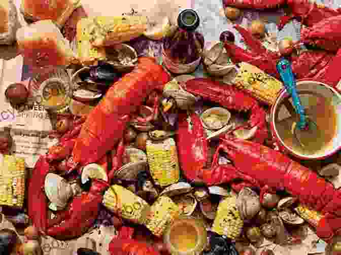 A Spread Of Freshly Cooked Lobsters, Clams, Mussels, And Corn On The Cob On A Rustic Wooden Table Overlooking The Ocean. Lobster Summer: A Celebration Of Coastal Living